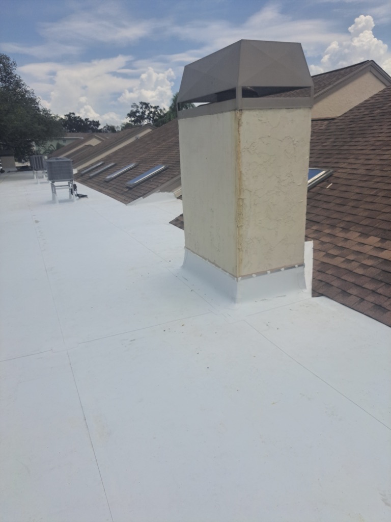 Flat roof repair with chimney flashing detail